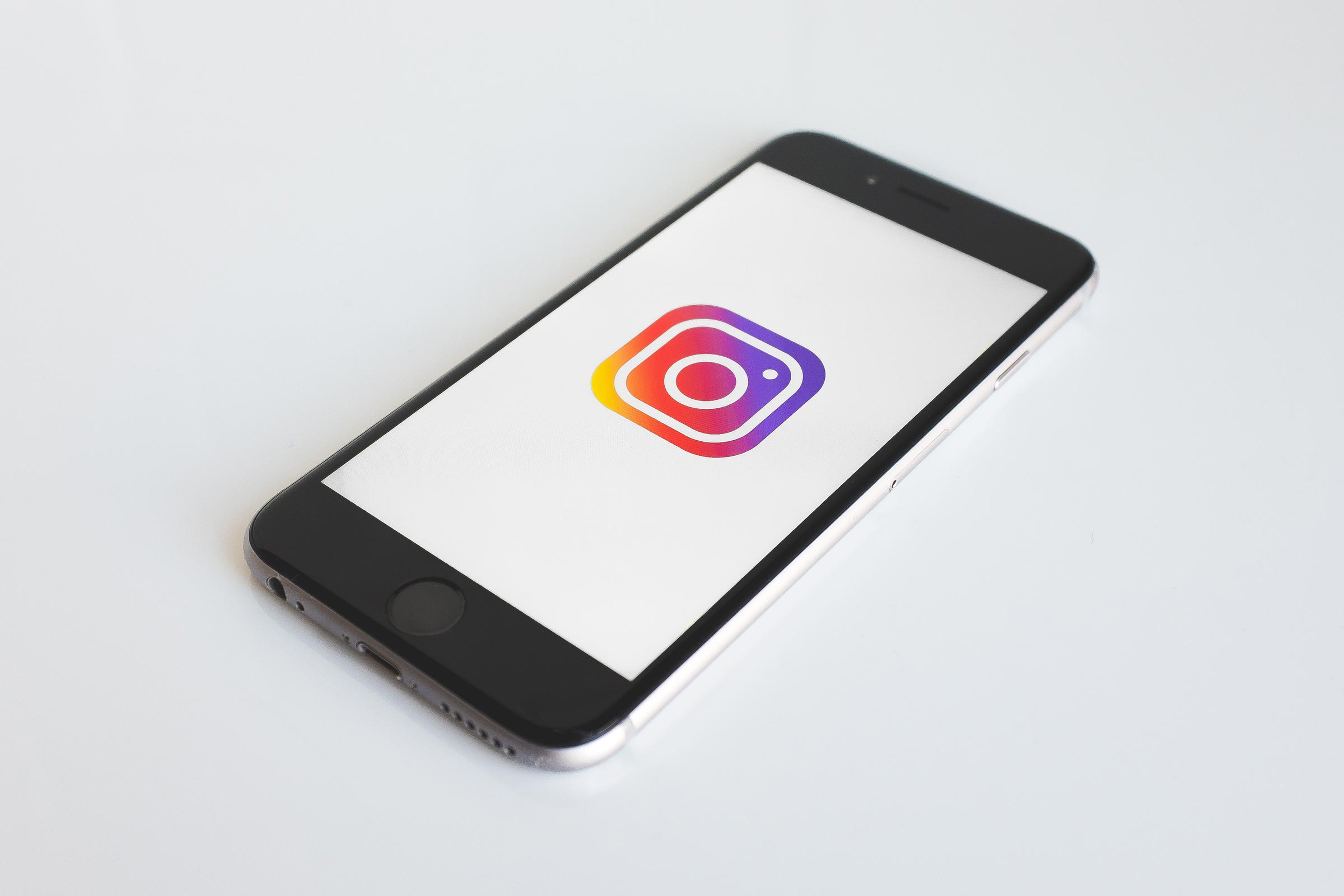 5 Expert Tips to Get More Engagement on Instagram Mobile Phone with Instagram Logo