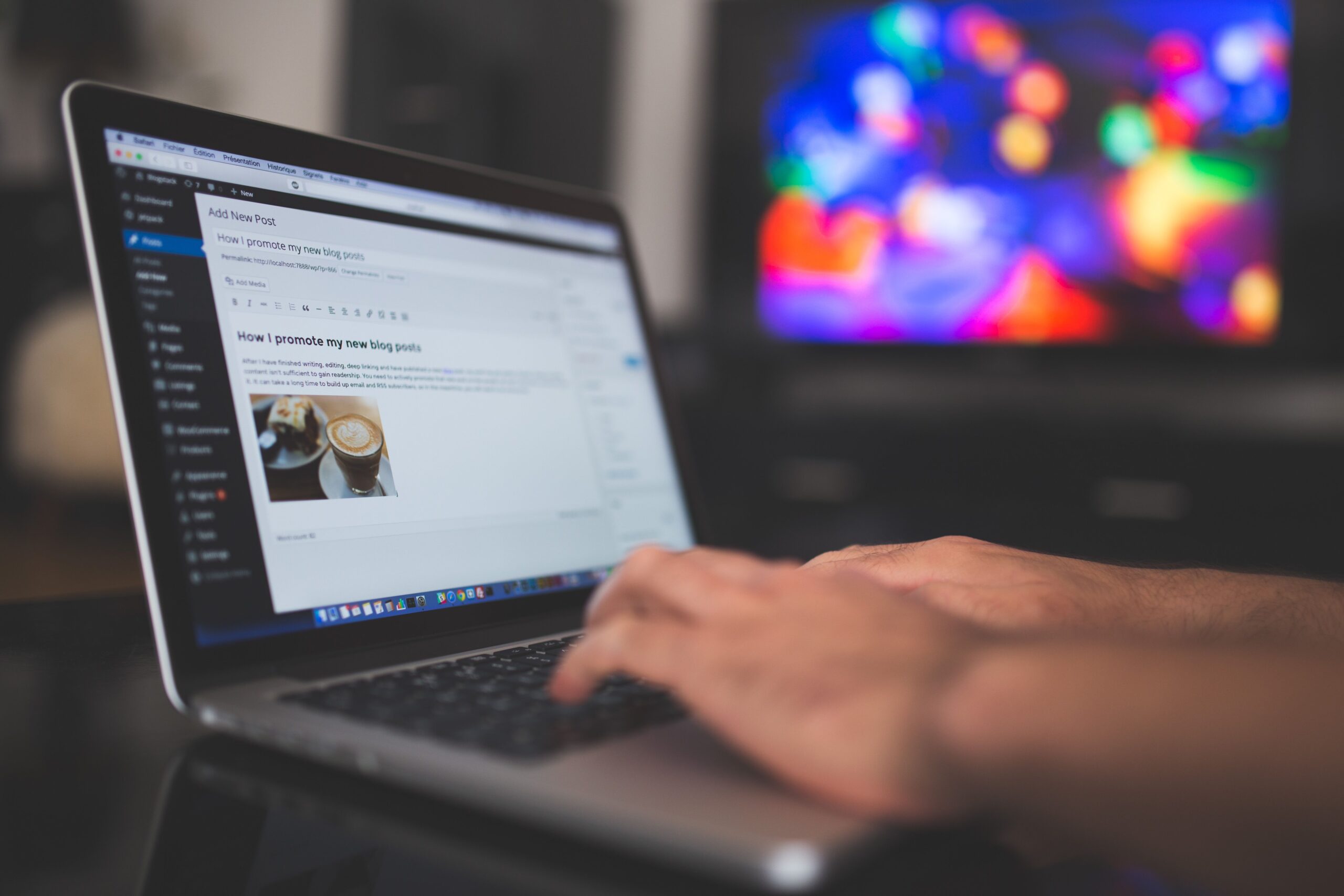 pexels photo 261662 261662 Hands typing on a laptop with a blog post visible, cozy indoor setting with colorful screen in background.